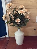 Overall view of vase with faux flowers