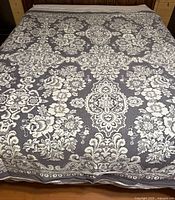 Full view of blanket spread on bed showing overall pattern