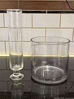 Both clear glass vases side by side showing relative sizes