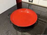 Full view of red enamel interior and twin handles