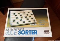 Front of boxed Logan E-Z View illuminated slide sorter showing product image and features list