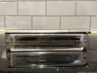 Front view of harmonica showing engraved model information