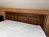 Full view of headboard attached to bed showing three panel design