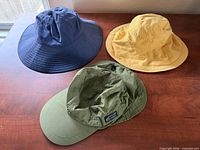 Top view of three hats showing colors and brim styles