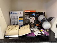 Group shot showing all boxed and blister-pack bulbs plus two Eaton outlet taps