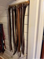Full view of belts hanging on rack showing quantity and length