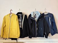 Six jackets hung side by side showing styles, colours and condition