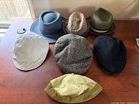 All seven hats displayed on table