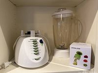 Blender base, separate pitcher with lid, boxed spiralizer on shelf