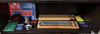 Overall lot showing both cribbage boards, bells, book and peg bags
