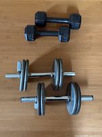 Two 10 lb hex dumbbells and two adjustable chrome dumbbells with plates