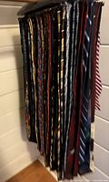 Group of neckties hanging on rack, left side view