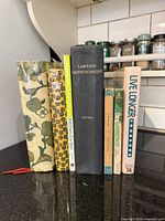 All seven books standing showing spines