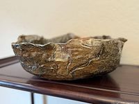 Side view of large wavy-rim stoneware bowl