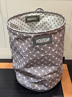 Front view of Nautica fabric laundry hamper showing shape, pattern, and handles