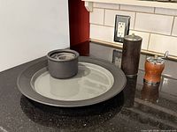 Platter, dip bowl, two wooden grinders on countertop