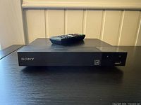 Front view of Sony BDP-S1700 Blu-ray player with remote on top
