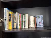 Entire shelf with all books and ceramic piece