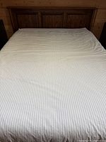 Blanket spread on bed showing overall size and stripe pattern