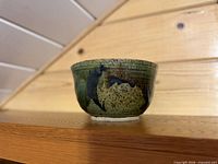 Side view of green stoneware bowl