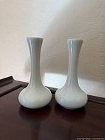 Front view of both white bud vases