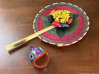 Fan and ceramic fish together on wood surface