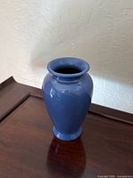 Overall front view of blue Scheurich vase on wooden surface