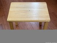 Top view of rectangular light wood side table showing surface and legs