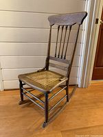 Full view of wooden rocking chair front left side