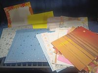 Overview of assorted letter-size cardstock sheets spread out showing multiple designs