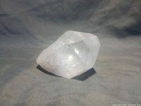 Side view of clear quartz point showing prism faces and termination