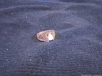 Ring top view showing opal and filigree band