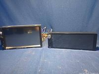 Front view of both 7023B car stereo head units side by side