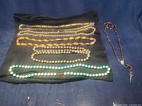 Overall view of all necklaces laid out on cloth