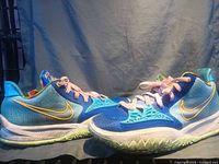 Side profile of both shoes highlighting colorway, swoosh, midsole and outsole