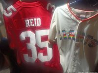 Rear view of 49ers Reid jersey and front of Giants rainbow jersey