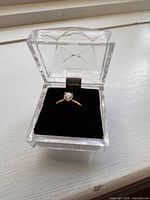 Ring displayed in clear acrylic presentation box