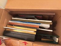 Box containing stack of various picture frames