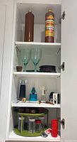 Full cabinet view showing all barware items on shelves