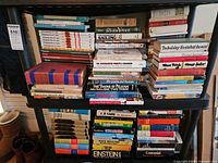 Front view of both packed shelves showing quantity and variety of books