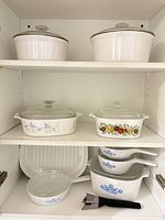 Cabinet view showing all casseroles, saucepans, grill pan