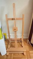 Front view of assembled wood tabletop easel showing adjustable center column and base