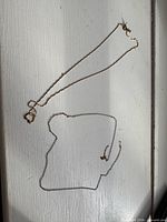 Both gold necklaces displayed