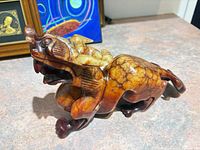 Left-side view of carved jade Foo Dog showing overall form and coloration