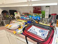 Countertop overview showing plates, bowls, wrap boxes, grinders, pitcher, utensils