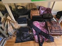 Group of purses, scarves and tie laid out on shelf and floor
