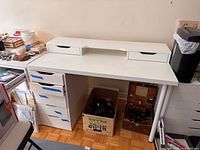 Overall view of desk with monitor shelf, metal leg, and adjacent five-drawer cabinet
