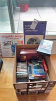 Overall lot with box of media, Raffi LP and other items visible