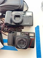 Front view of both Nikon cameras showing lenses and branding