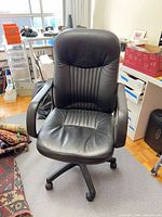 Front view of black faux leather office chair